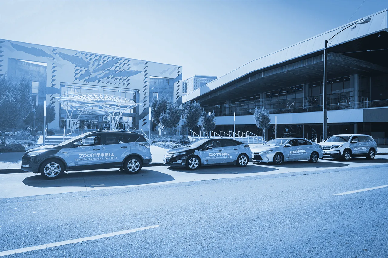 Fleet of Zoomtopia (Zoom Video Communications) wrapped rideshare cars parked outside the San Jose Convention Center