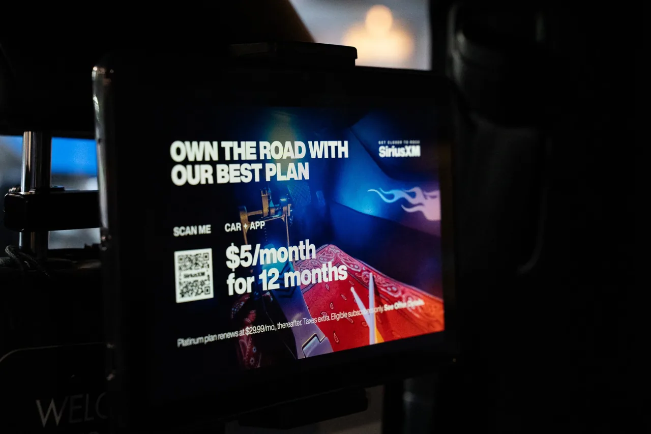 Digital backseat/in-vehicle screen showing a SiriusXM subscription offer (Wrapped Media interior media)