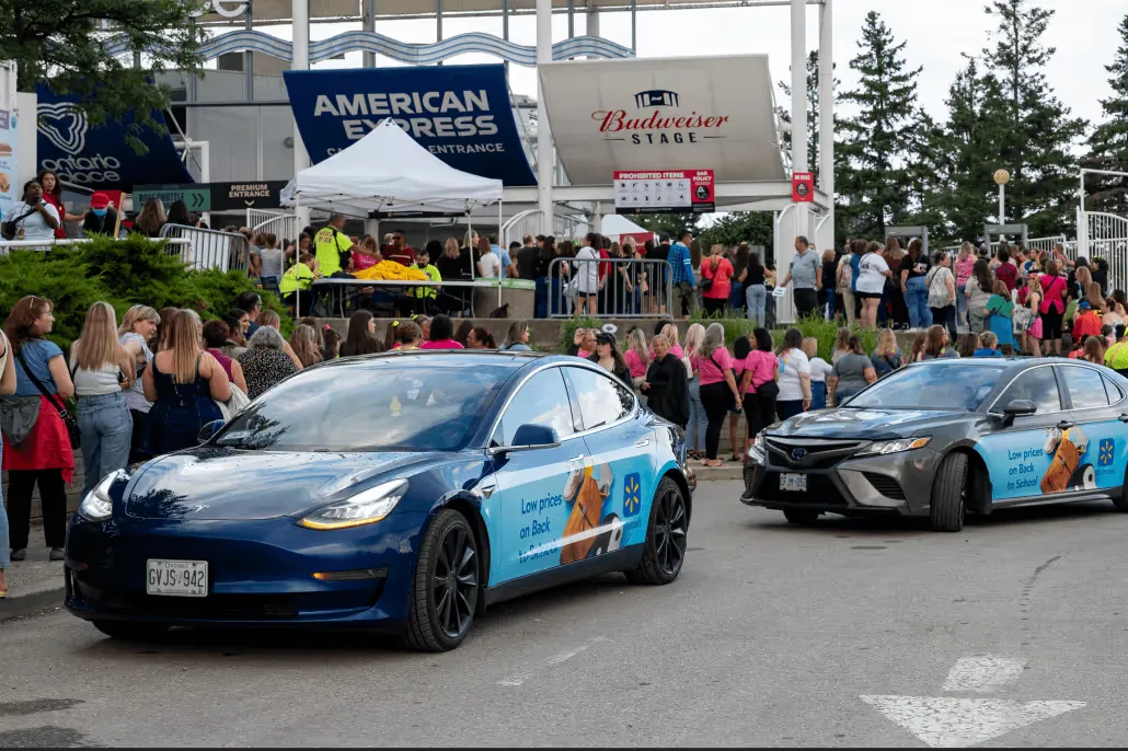 Two Walmart back-to-school wrapped vehicles staged at an outdoor event venue (Wrapped Media campaign)